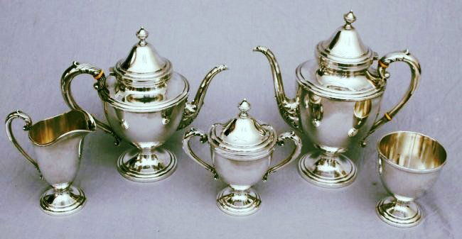 FRANK M. WHITING STERLING SILVER LARGE 5 PC TEA SET: Frank M. Whiting Sterling Silver Large 5 Pc. Tea Set. The George III style sterling tea and coffee service consists of a covered coffee pot, covered tea pot, covered sugar urn, tall open creamer and w