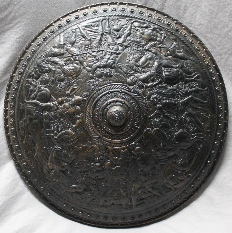 LARGE ITALIAN CERAMIC ROMAN SHIELD: A Large Italian Ceramic Roman Shield painted bronze. High relief, fine detailing and highly decorative. Measures 20 inches diameter 3 inches deep. 6 Pds. Provenance: A Charleston SC Private Estate