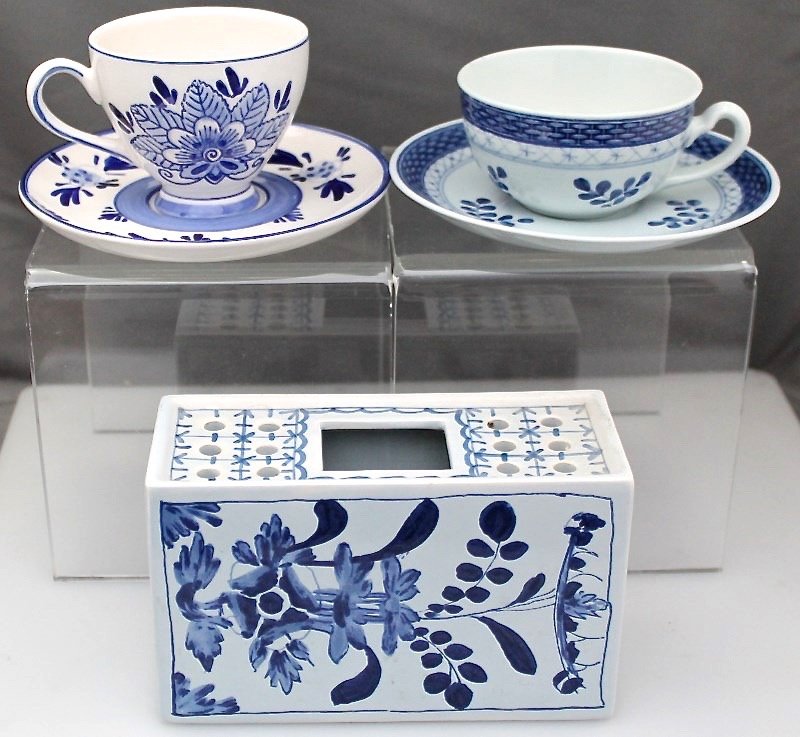 LOT OF 3 HAND PAINTED DELFT VASE AND CUPS: A great grouping of 3 Vintage Delft Ware Pieces. The first a Vase Flower Frog manufactured by Oud Delft, Nijmegen Waddinxveen, measuring 6" long . 1 Elevsa, Holland Tea Cup and Saucer and 1 Royal Cope