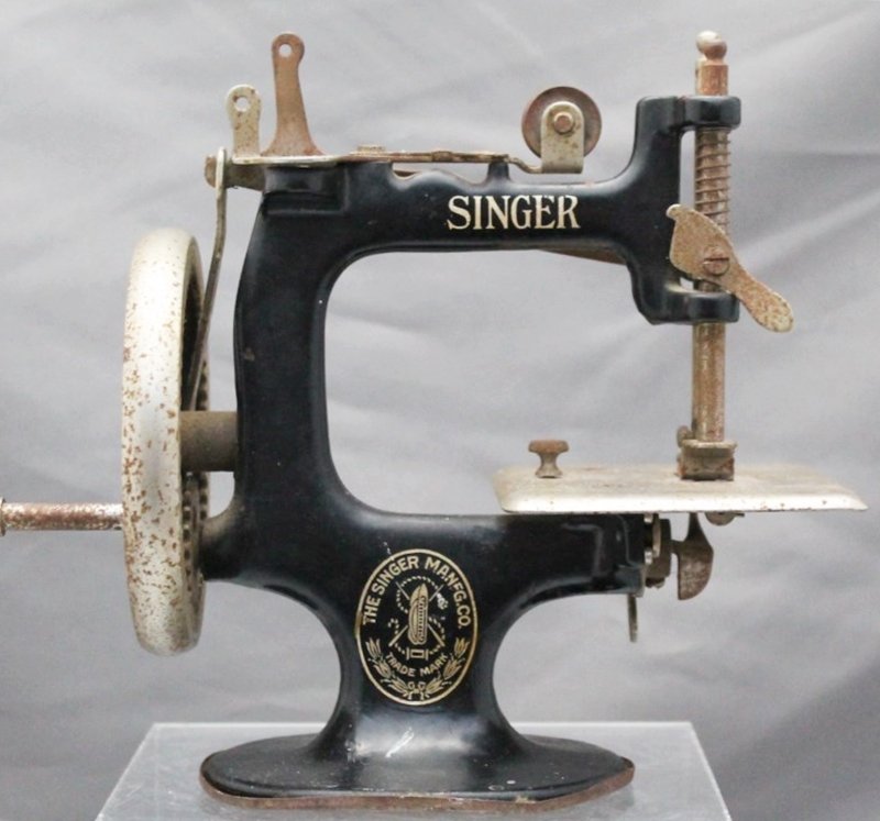 CHILDS TOY SINGER SEWING MACHINE MODEL 20: 1920s Childs Cast Iron Toy Singer Sewing Machine. Still has the original needle and can produce a simple chain stitch. The Singer Sewing Machine Model 20, known later as the sewhandy, was the most suc