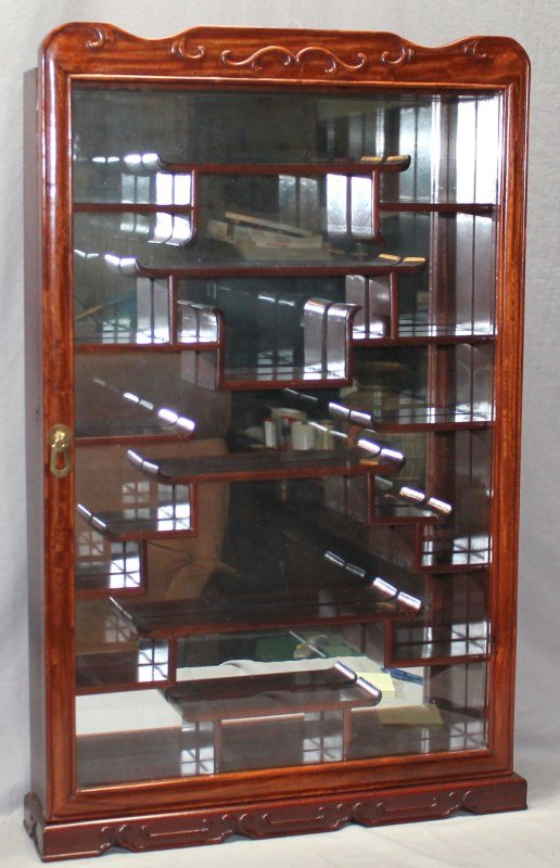 CHINESE ROSEWOOD WALL DISPLAY CABINET: Chinese, 20th century good quality display. Chinese rosewood wall display cabinet designed for snuff bottles, miniatures or netsukes with many staggered shelves and a mirrored back and with glazed doo