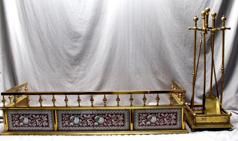19th c. AESTHETIC MINTON BRASS FIREPLACE FENDER & TOOLS: A very good brass 19th c. Aesthetic Movement fireplace fender having stylized pomegranate decorated attributed to Minton tile inserts. With 19th c. set of brass fireplace tools that had a matching til