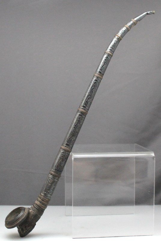 ANTIQUE OPIUM PIPE: A 19th century opium pipe with an ornate clay bowl and decorated silver and copper decorated stem.Â Most likely from Thailand. Unglazed clay, chip to bowl base and 3 nicks to bowl rim. Dent to top o