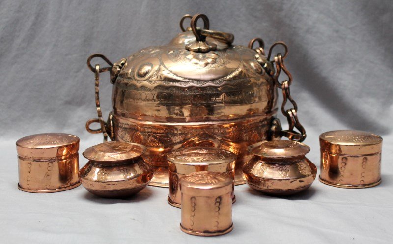 ANTIQUE ORNATE COPPER & BRASS SPICE BOX: Large Antique Ornate Indo Persian Copper Spice Box. All hand hammered with hand forged hardware. Interior contains 6 covered ornate lidded spice jars and a ornate hand hammered tray. PROVENANCE: A Hil