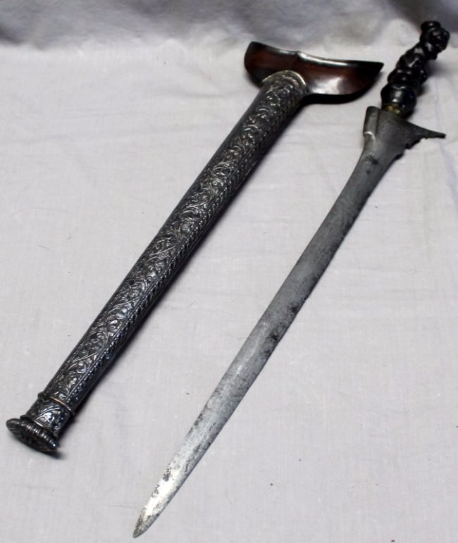 INDONESIAN KERIS KRIS DAGGER WITH SCABBARD: Fine Indonesian Keris kris Dagger, Sumatra,19th c. The silver sheath with a ornate repousse scroll and floral pattern and a wooden guard. PROVENANCE: A Charleston, SC Private Collection. 19 x 2 x 4.75