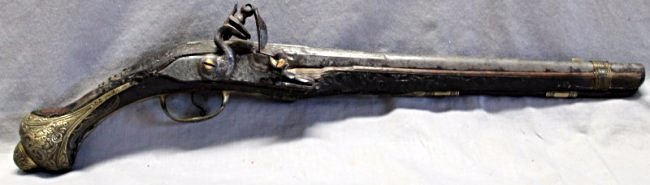 OTTOMAN EMPIRE FLINTLOCK KUBAR PISTOL: Early 19th Century Ottoman Empire Flintlock Kubur Pistol. Ornate scroll work and brass butt cap. Small loss to one side wood. Measures 20.75 x 2.25 x 6. PROVENANCE: A Charleston South Carolina Private