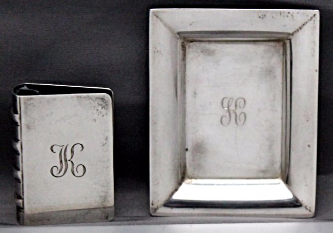 TIFFANY STERLING MATCHBOOK COVER AND TRAY: Tiffany figural book matchbook cover and tray. Of rectangular book design with open sides. The book spine is marked Tiffany & Co Sterling. The tray is marked Tiffany & Co Makers 20958. Monogrammed K. 