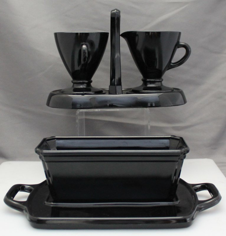 5 pc VINTAGE BLACK AMETHYST GLASS: 5 Piece Vintage 1930s Black Glass. Includes a hazel atlas cream and sugar, each approx 3.50 tall. Caddy is a deco style 8x4x5.75. Covered butter. Black tray 10.25x6 and rect planter 3 ods 12 oz. PROVE