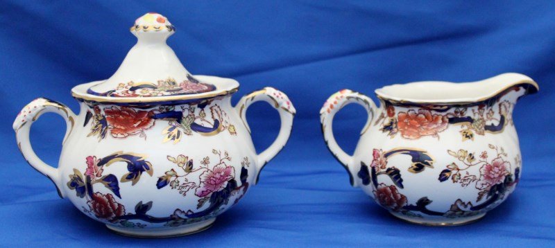 2 PC MASONS IRONSTONE MANDALAY CREAM & SUGAR: Older Masons Ironstone Mandalay cream and sugar. Covered sugar measures 6x6x5. Creamer 4x5x3. Hand decorated in 22 carat Gold. Very good condition. PROVENANCE: A Charleston South Carolina Private Esta