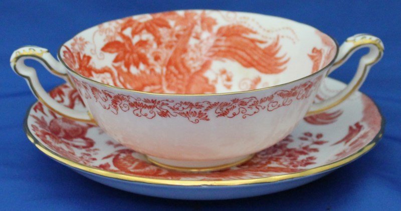 RED AVES ROYAL CROWN DERBY CREAM SOUP: Vintage Red Aves Royal Crown Derby Footed Cream Soup Bowl and Saucer. Red Birds & Flowers, Gold Trim. Good condition. PROVENANCE: A Pennsylvania and Kiawah Island Private Collection. Cup 6.50x5x2. Sau