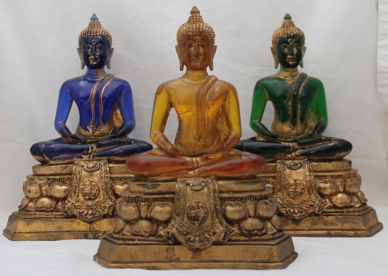 3 PC MEDITATING BUDDHAS: 3 Piece Contemporary 20th century decorator blue, amber and green lucite or resin buddhas on plaster bases. Tozai home. 7x4x9. wt on all 3 12 pds. PROVENANCE: A Pennsylvania and Kiawah Island Private