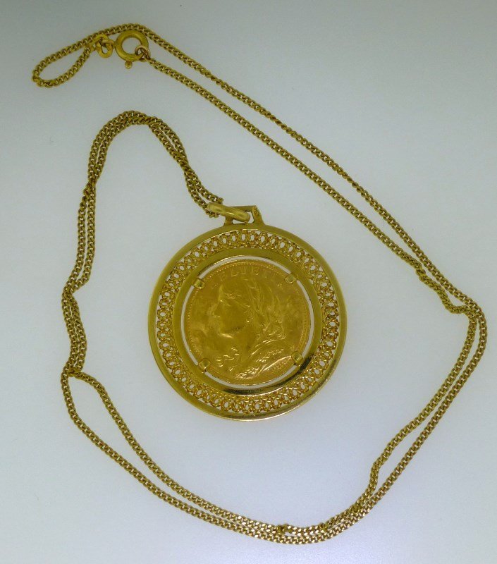 18KT GOLD & 22KT GOLD COIN NECKLACE (16.60 GRAMS): This is a great investment that just happens to be a beautiful piece of jewelry! This beautiful 1935 Swiss 20 Franc Helvetia coin pendant is on a 22.50" 18kt yellow gold curb chain. The pendant mounti