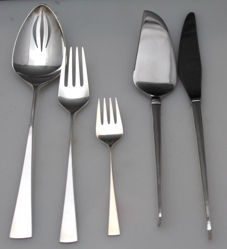 5 PC STERLING JOHN AXEL PRIP REED & BARTON DIMENSION: True, classic mid century modern sterling silver flatware. Five pieces of Reed & Barton 1961 Dimension designed by John Axel Prip. Includes a Pierced Table Spoon 8 1/2", a Baby Fork 4 3/4, a Pie & Cak