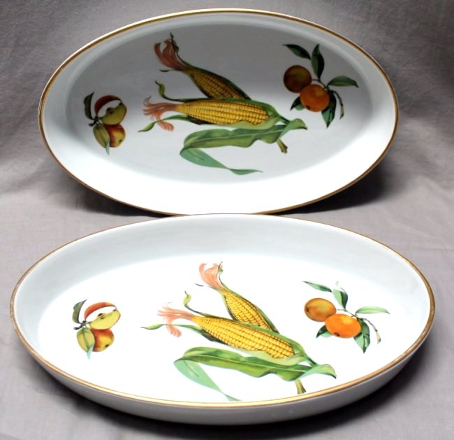 PAIR (2) EVESHAM GOLD ROYAL WORCESTER BAKERS: A pair of Royal Worcester Porcelain Evesham Bakers. Each measures 14 5/8x8 3/4x2. Evesham Gold is a classic porcelain pattern developed in 1961, depicting the autumnal fruits of the Vale of Evesham wi