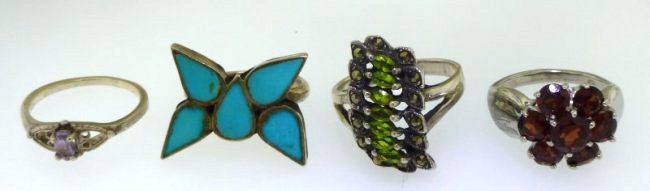 4 ESTATE STERLING AND GEMSTONE RINGS: 4 Estate Sterling Silver and Gemstone Rings. A amethyst in a open heart setting size 5.75, a garnet flower size 5, a peridot and marcasite size 7.25 and a turquoise butterfly size 5. All marked 925 ex