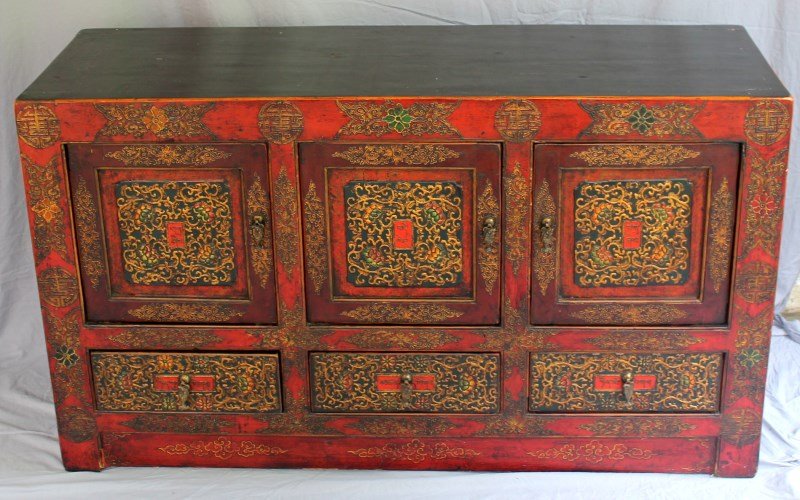 HAND PAINTED TIBETAN ALTAR CABINET: Hand painted 20th c. Tibetan Altar Style Cabinet. Fabulous color and design 3 Doors over 3 drawers. Original iron fish hardware on all three doors and drawers. PROVENANCE: A Charleston SC Private Coll