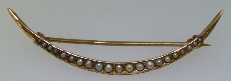 EDWARDIAN 10KT GOLD SEED PEARL BROOCH: This is a beautiful Edwardian era half moon design seed pearl brooch. The brooch is 10kt gold and features a total of 21 seed pearls set in a half moon style. The pearls slightly graduate with the lar