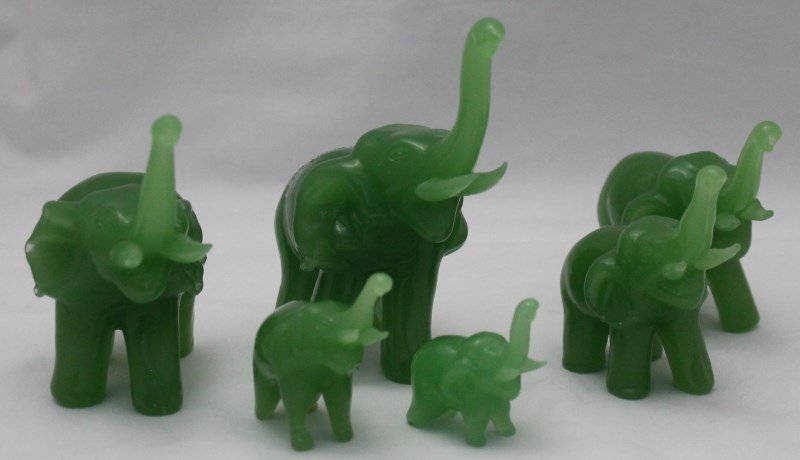 6 JADEITE GLASS ELEPHANTS: Vintage Green Jadeite Colored Glass Graduated Size Elephant Figurines Set of 6. All with trunks raised for good luck. Largest 4.25 tall. Weight 12 oz PROVENANCE: A Charleston SC Private Estate.
