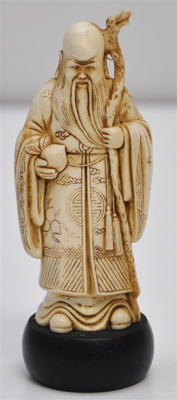 CARVED BONE SHOU GOD OF LONGEVITY: A vintage finely detailed carved bone Shou, Chinese God of Longevity. On ebony stand. The Shou star is the star of the South Pole in Chinese astronomy, and is believed to control the life spans of mor