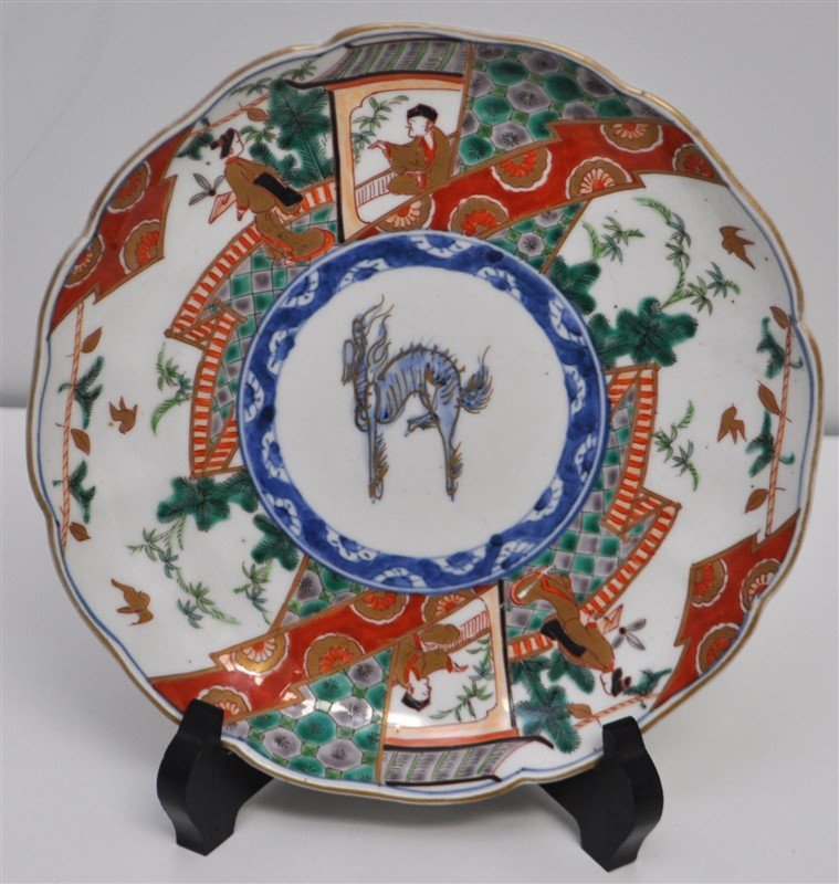 EDO PERIOD ANTIQUE IMARI PLATE: A Edo Period Japanese Imari Plate, of circular form with a central scrolling dragon surrounded by panels enameled with Japanese Pine and Figures in Reds, greens and blues with gold accents. A old prof