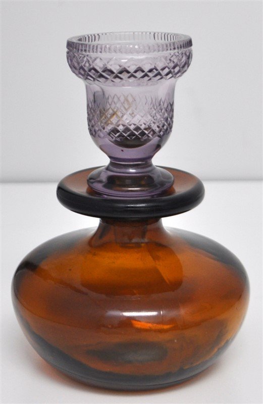 MID CENTURY FINLAND AMBER GLASS DECANTER PURPLE STOPPER: A Mid Ventury Amber Decanter with Purple Shot Glass Stopper. A great way to have a small nip, perfect for nightstand or side table. Decanter with hallmark and Finland. With stopper 4x4x5.65 tall. Wt.