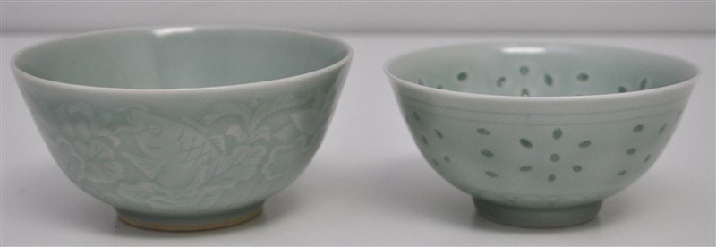 2 CELADON RICE BOWLS KOI & PIERCED: 1. A Celadon Rice Bowl bowl with pierced and glazed geometric design. The bowl is signed. Measures 4.50x4.50x2.25. 2. A footed bowls with low relief koi fish among aquated vegtation 5x5x2.50. Wt. comb