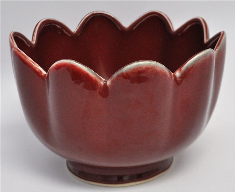 CHINESE SANG de BOUEF LARGE LOTUS BOWL: A Chinese Oxblood Lotus Bowl. Chinese, likely 20th century. Of good quality and displays well. Sang de Bouef (French: Oxblood) is an opaque claret red to brownish red reduced copper glaze developed in