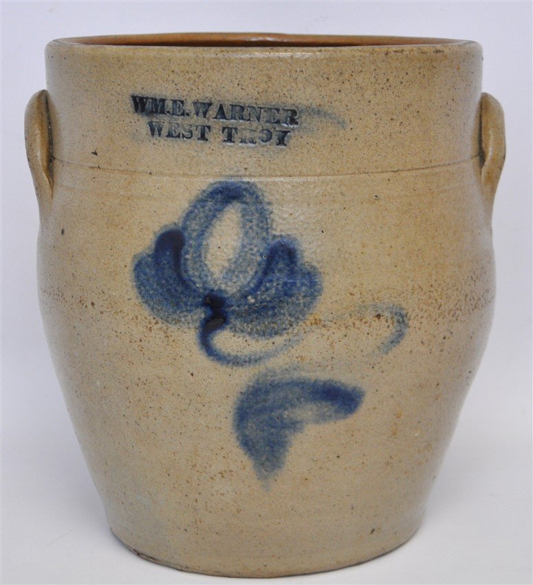 c. 1850 WM E WARNER COBALT DECORATED CROCK: One-Gallon Cobalt-Decorated Stoneware Crock, Stamped WM. E. WARNER / WEST TROY, NY State origin, circa 1850, cylindrical crock with applied lug handles, decorated with a large brushed cobalt tulip. Ex