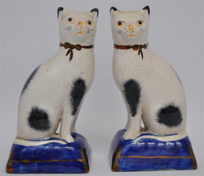 PAIR 19TH c. STAFFORDSHIRE SEATED CATS: Delightful pair of 19th c. English Staffordshire Black and White Cats seated on Blue Cushions. cobalt cushions, circa 1860. Excellent sponge painted bodies, dull mercurial gold line to cobalt pillow b