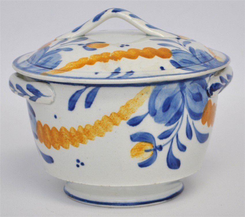 ANTIQUE FAIENCE LIDDED BOWL: Antique Faience Lidded Bowl, Painted in primary yellow and blues. Applied handles to sides of bowl and lid. Measures 5.25"x4.50"x 4.25". Weight is 14. oz. PROVENANCE: The Private Estate of a Atlanta,