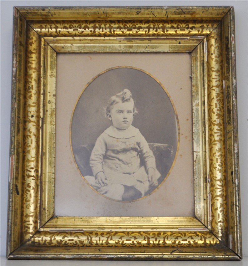 ANTIQUE STERN FACED CHILDS PHOTOGRAPH SHADOWBOX: A Antique Stern Faced Childs Photograph in a Gilded Victorian Shadow Box Frame. In Frame Measures 15.50"x17.5-"x2". Weight is 4 pds 10 oz. PROVENANCE: A Private Charleston Estate.