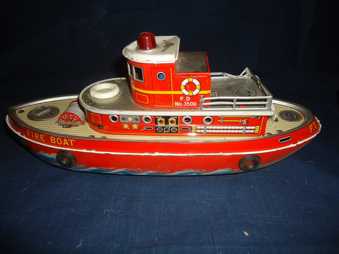 Fire Dept Boat- Battery Operated: tin lithographed fire dept boat, damage to upper railing ( se photos) surface wear- minor, 14" in length, Modern Toys- Made in Japan
