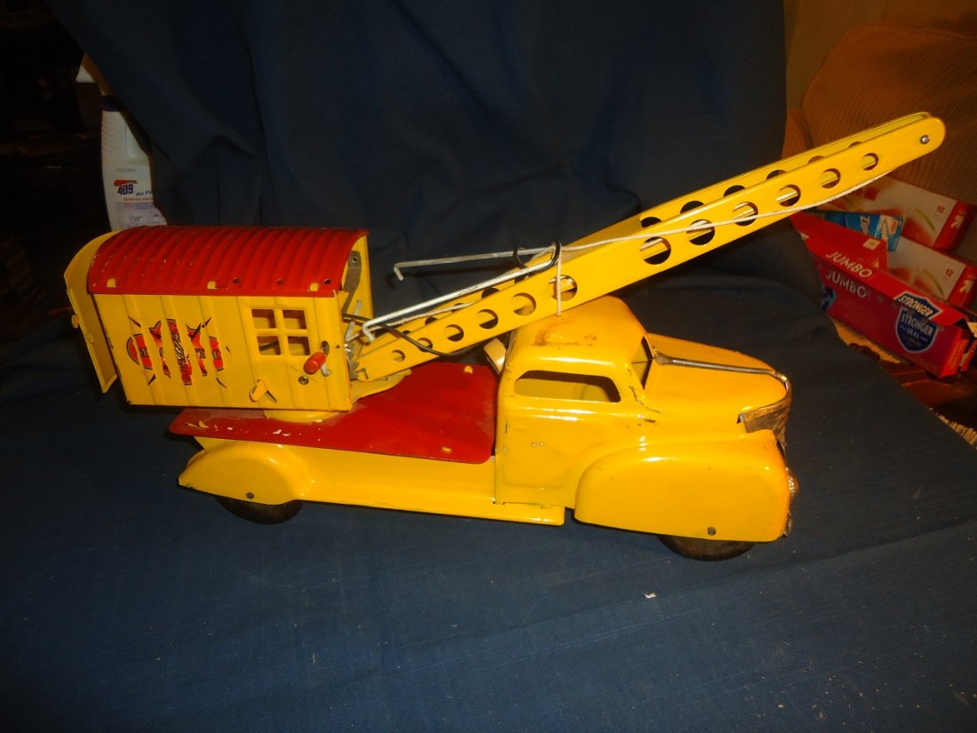 Vintage Metal Crane: Steel toy, crane near mint, paint issues to decals on both sides. Back decal mint. 17 1/2" in length.