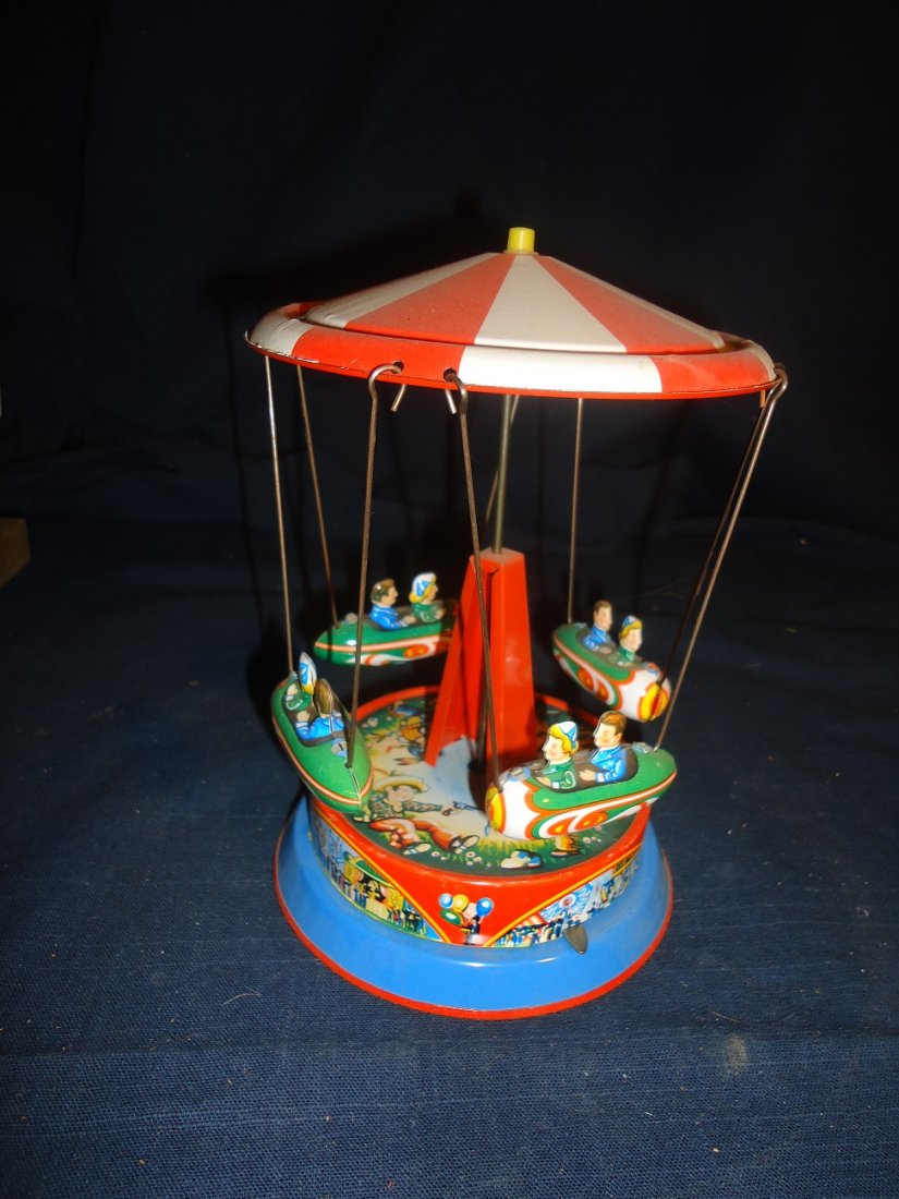 West German Tin Litho Merry Go Round: Working order, 7 3/4" tall with a diameter of 5 3/4" MINT