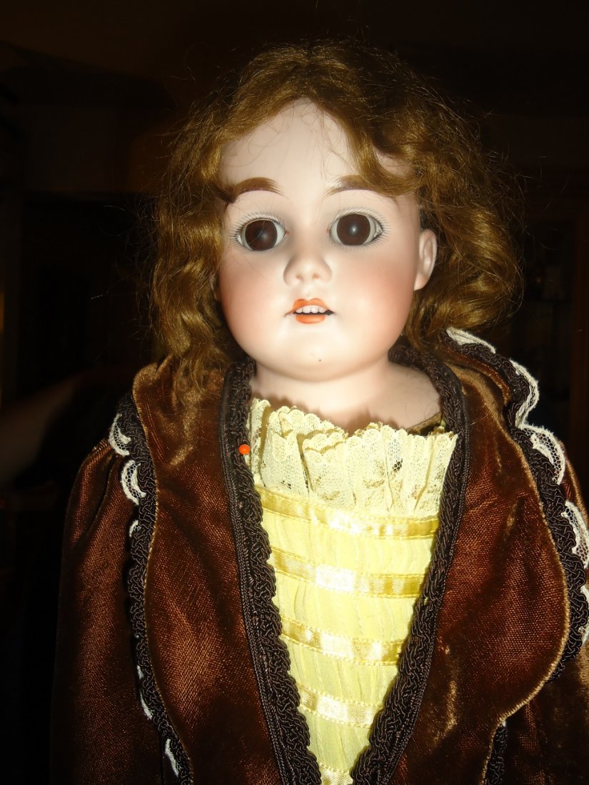 26" German Bisque Headed Doll: Incised- St then in a diamond H W & COon either side of the diamond A M 5Made in GermanyHuman hair wig, bisque hands, both hands damaged, bisque arms to elbow, kid leather body, fixed eyes. Shoulder h