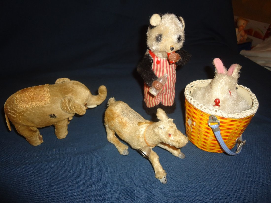 Four Vintage Wind-Up Toys: Four non-working or sluggish plush wind-up toys. Elephant, no key, wear around left eye. Tears in fabric, sluggish. 6 1/4' length. Reindeer, Made in Occupied Japan, missing ear & horns, fabric fur lig