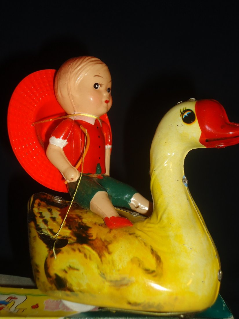 Riding Goose Wind-Up Toy: Chinese made, celluloid cowboy on tin lithographed goose- working order with box. 5 1/2" tall.