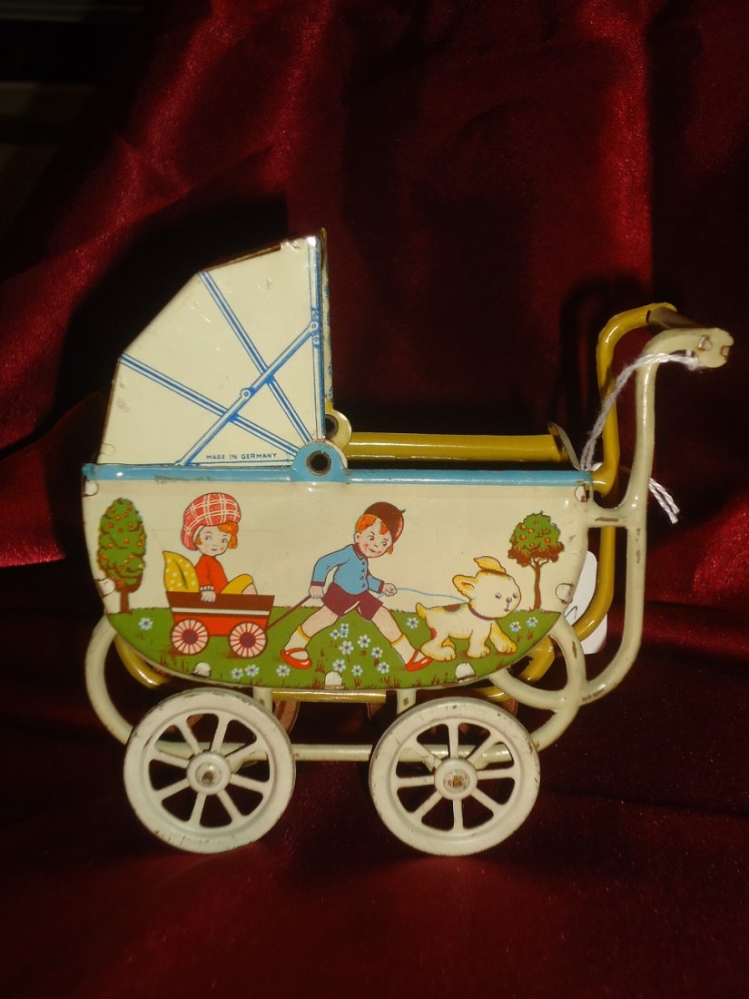 German Tin Lithographed Baby Carriage: Mint surface, German 1915-20. 5 1/4' in height x 5 1/4" in length. Adorable.