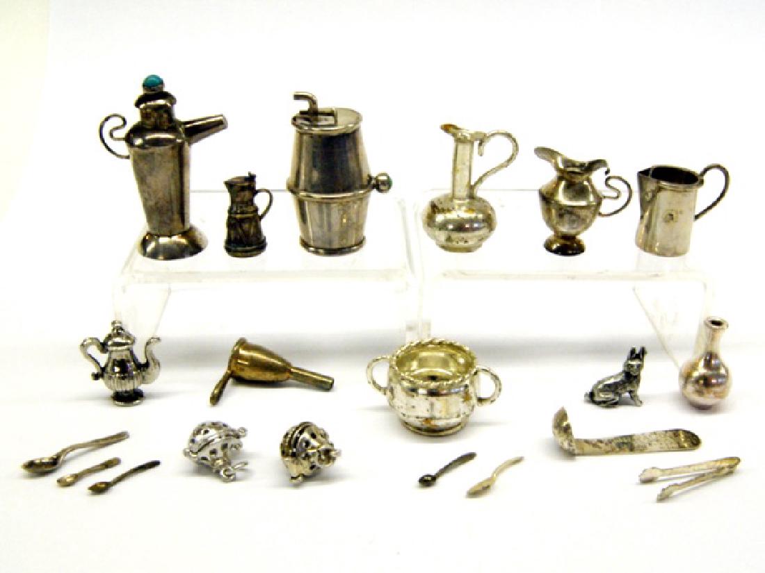 Large Group Silver Miniature Table Items: Wine barrel with tap 1.5"L, teapot with stone finial 1.6"H, double handle mug, four pitchers, teapot, vase, two tea balls, funnel, sugar tongs and flatware, rabbit