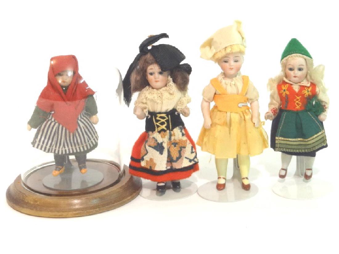 Four Small Bisques and Dome: Original 4in. All bisque, glass eyes, mohair wig, white socks, blue garters and black single strap shoes, tiny heels 4in. Original all bisque, sleep eyes, mohair wig, long yellow stockings and brown s