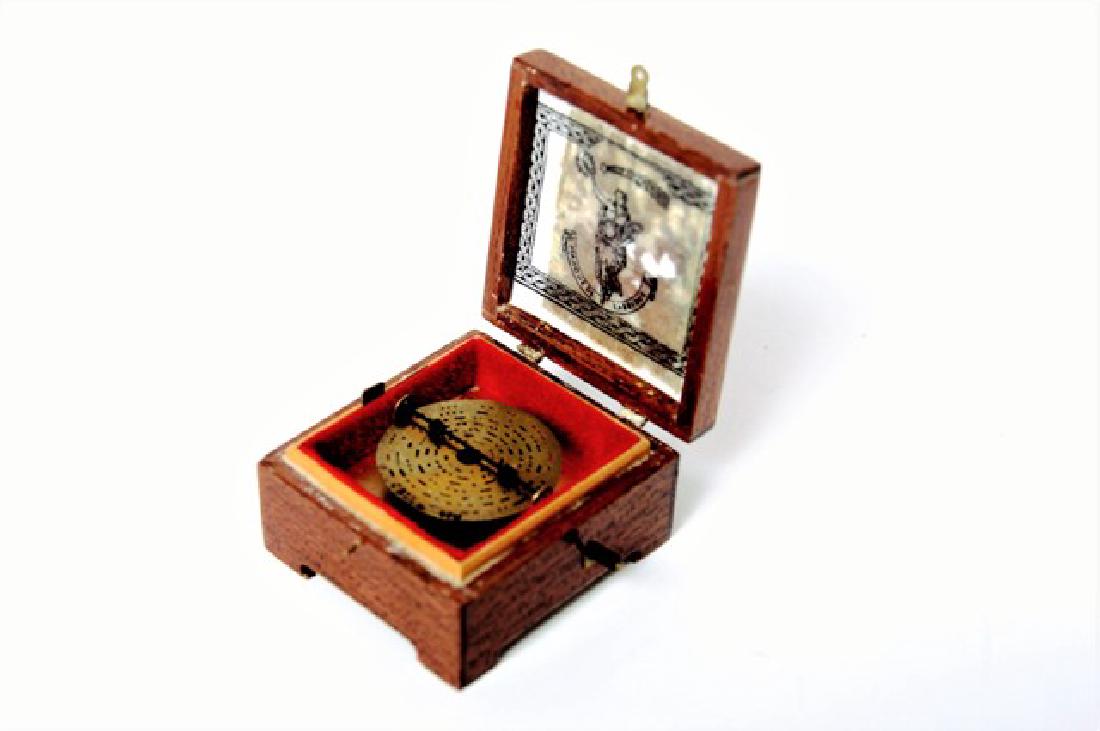 S.J. Whitehouse Cased Disc Player Dollhouse Miniature: Exotic hardwood polyphony disc player box with inlaid burl wood and light wood stringing 1 1/4" x 1 1/8" x 3/8"H, plays tune when opened, LE 623/647, with original box