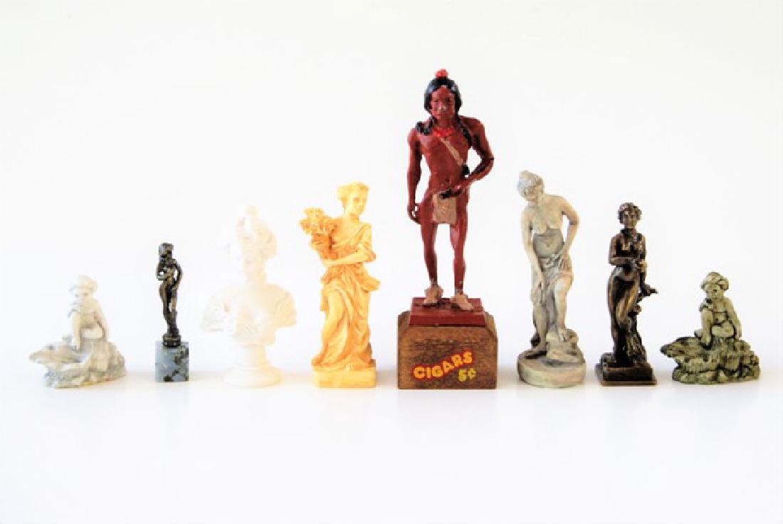 Group of Dollhouse Statues: Solid bronze Eve holding apple 2 1/8" H with illegible signature, bronze nude on stone base, painted cast metal cigar store Indian on wood plinth 3.75"H, and four cast figures