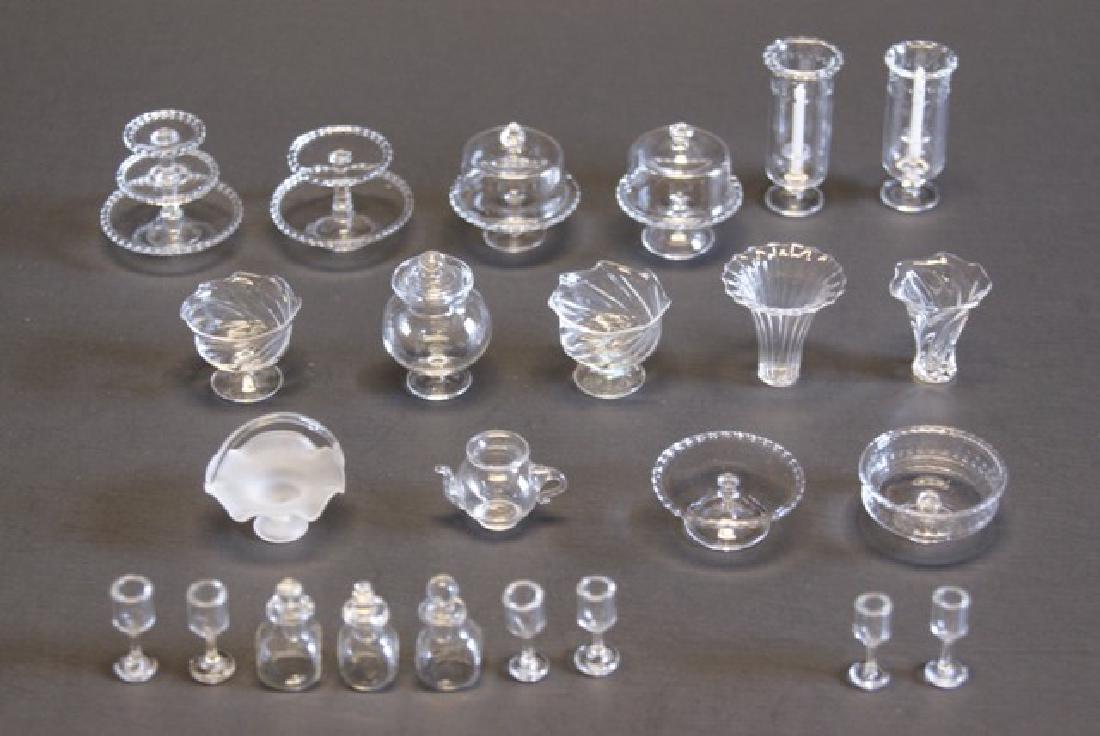Large Lot of Clear Glassware for Dollhouse: Large lot of clear dollhouse miniature glassware, single, double and triple level dessert stands, covered cake stand, vases, pair of hurricane lights, pitcher, frosted bride's basket, three decanters 