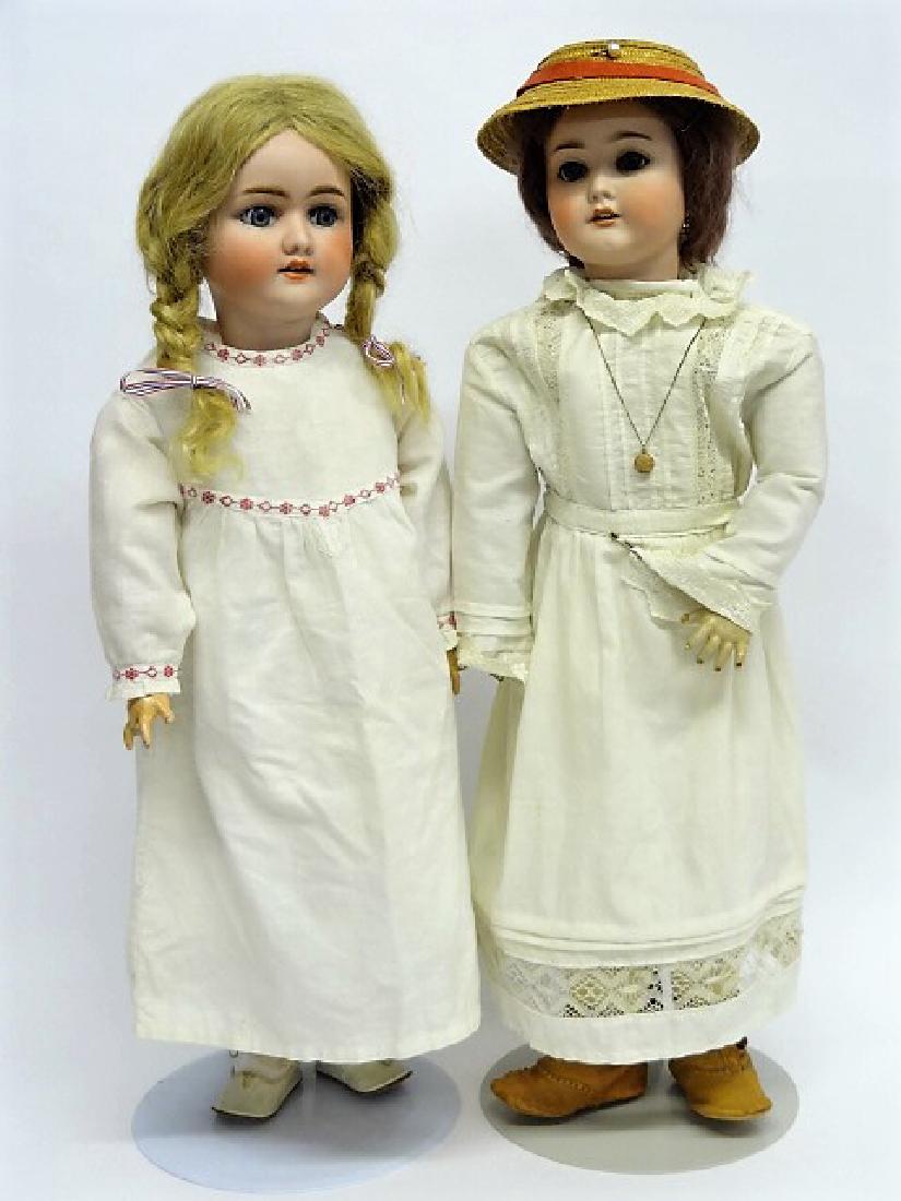 Two Bisque Dolls S & H, A & M: Simon & Halbig 23" bisque doll, redressed with old shoes, #1923, glue on damaged head, body is ok, sleep eyes, A&M Special, redressed, old shoes, wig replaced, eyes stationary, one tooth missing, 24"