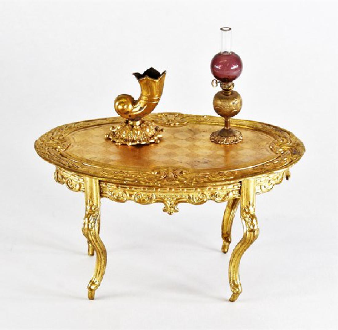 Antique Dollhouse Ormolu Table & Accessories Miniatures: Antique ormolu cornucopia form vase 1.25"H, parlor lamp with glass globe 2"H, oval table 4.75"W, 3.25"D, 2.75"H
