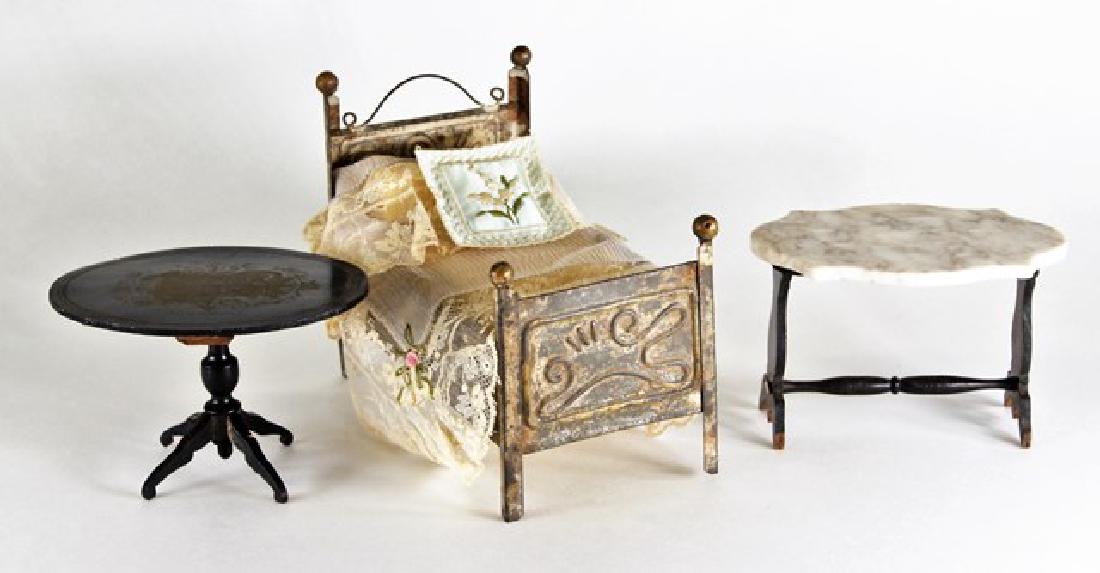 Antique Dollhouse Biedermeier & Tin Furniture: Antique Biedermeier oval table with stenciled scene of Reinhardsbrunn 4.5"W, 3.5"D, 3"D, marble turtle top table with Biedermeier base 4.75"W, 3.25"D, 3"H, antique embossed tin bed 6"L, 3.25"W, 5"H