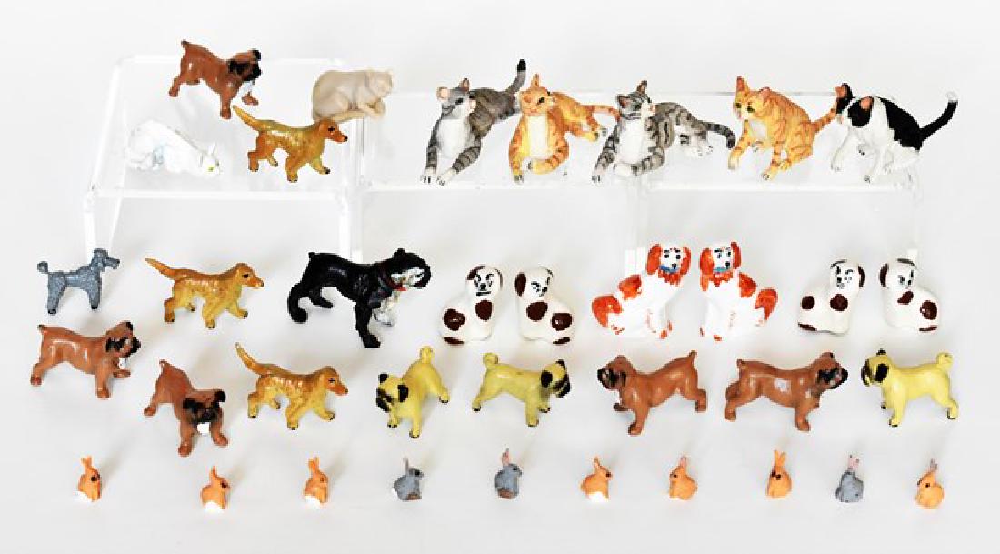 Large Lot of Dollhouse Cats, Dogs & Rabbits Miniatures: Five hand painted artisan cats average length 2" and ten tiny rabbits, three pairs of china Staffordshire style dogs 7/8" to 1.25"H, thirteen hand painted pewter dogs and a pewter cat