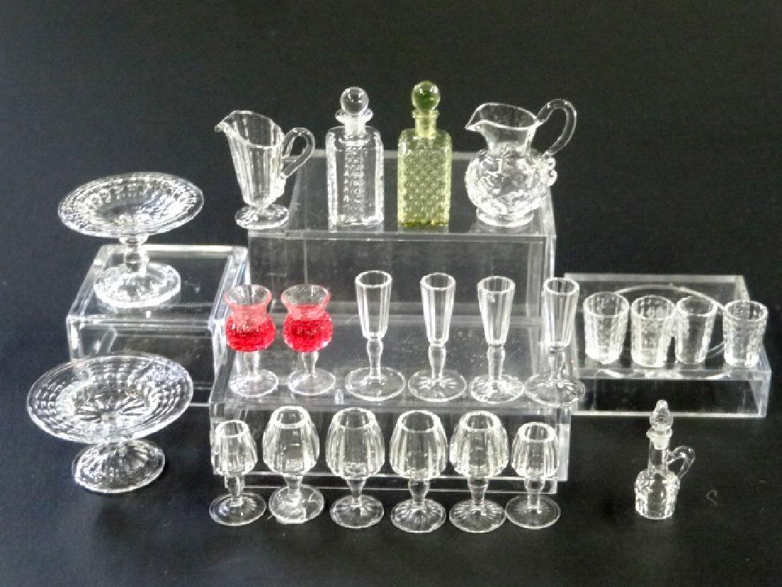 Ferenc Albert Dollhouse Glassware Miniatures: Ferenc Albert artisan dollhouse glassware, two sizes of compotes largest 1"W, two styles of pitchers, tinted decanter with pair of filled wine glasses, clear decanter with six wine glasses, pair of ch