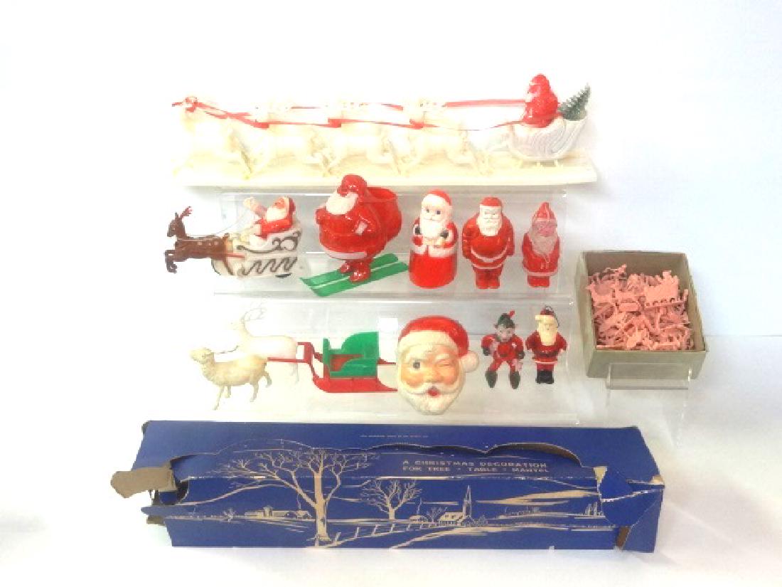 Vintage Plastic Christmas Decorations: Vintage plastic sled with eight reindeer 18"L has partial box, Santa on skis 4.5"L with partial box, Elmar friction sleigh, friction Santa 3.75"H, winking eye Santa head, plastic Santas, reindeer and