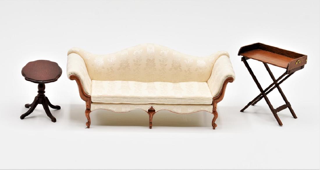 Olson Sofa & Jenvey Table Dollhouse Miniatures: Noral Olson upholstered camel back sofa with mahogany frame 7 1/8"W, 3"H", 3"D, Dennis Jenvey mahogany butler's tray on folding base 2 5/8"W, 3"H and a side table with illegible mark 2 5/8"W